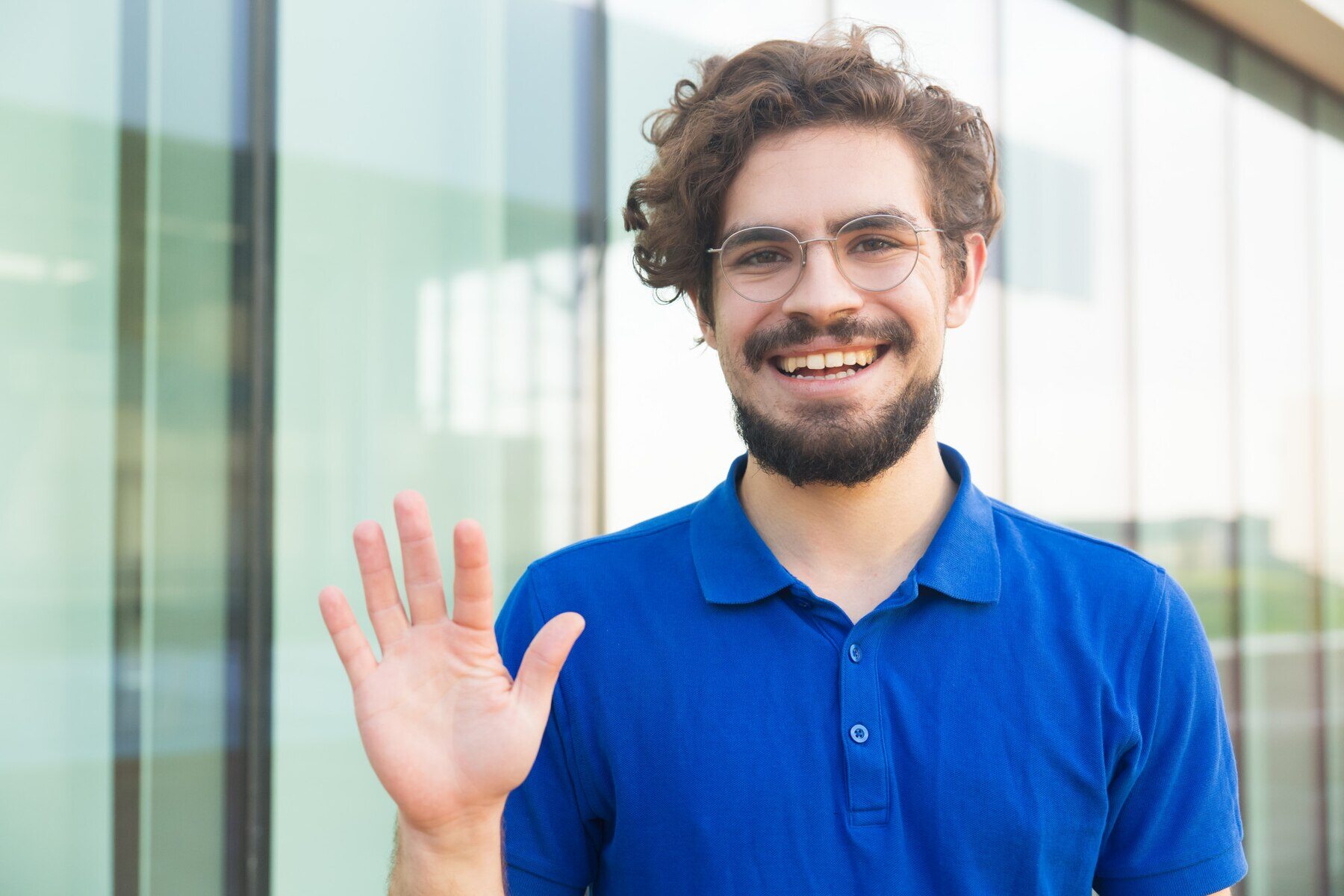 happy-friendly-guy-wearing-glasses-waving-hello_74855-3484